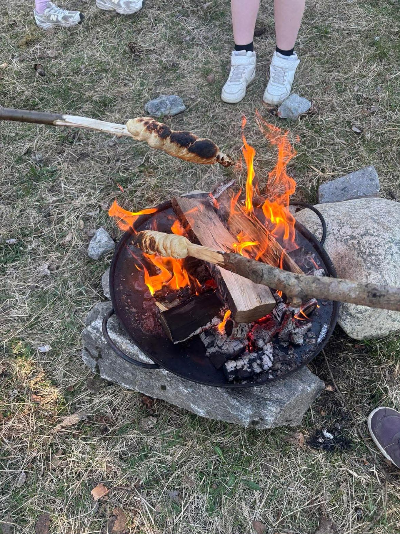 a fire pit with a stick and a fire in it