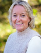 en person som smiler til kameraet